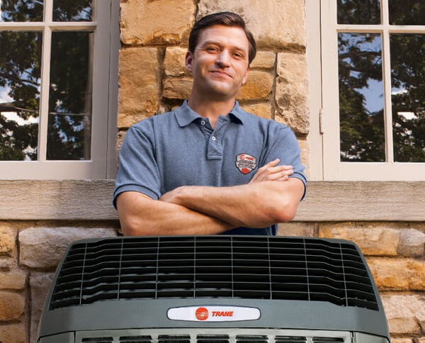 Trane Tech Standing Behind Air Conditioner